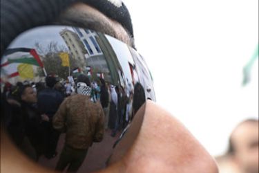 r_Protesters are reflected in the sunglasses of a fellow protestor during a demonstration held outside the United State Embassy in Manama, to protest against U.S.