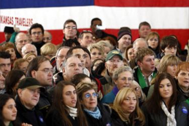 New Hampshire voters stand in front of a U.S. flag at a campaign rally for Senator Hillary Clinton (D-NY) in Nashua, New Hampshire January 4, 2008