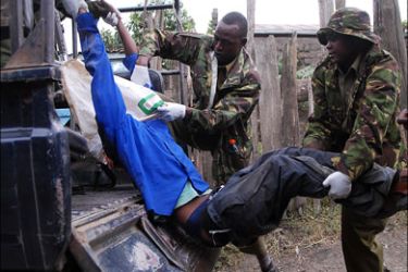 afp : Kenyan police load the body of a fifteen-year-old boy who was hacked to death during ethnic clashes in Nakuru into a police truck 27 January 2008. More than 850 people
