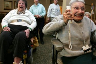 Jeanne Gildea (R), 81, reacts to a shot as she plays in a bowling tournament against fellow community members, including Elaine Fowler (L), 82, on the Nintendo Wii game system at the Riderwood Retirement Community in Silver Spring, Maryland, 16 January 2008