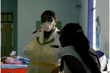 A nurse cares for patients 23 January 2008 in a cordoned off wing of the extreme drug resistant tuberculosis (XDR-TB), a near untreatable strain of the disease, at the Brooklyn Infectious Disease Hospital in Cape Town