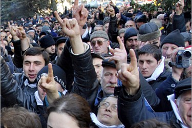 .AFP / Georgian opposition supporters shout during a rally near the television center in Tbilisi, 15 January 2008. Some 5,000 Georgian opposition supporters rallied on Tuesday to