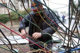 An Iraqi electrician fixes entangled wires providing electricty to apartments from a 200 KW generator in Baghdad's Salhiya neighbourhood, 26 January 2008