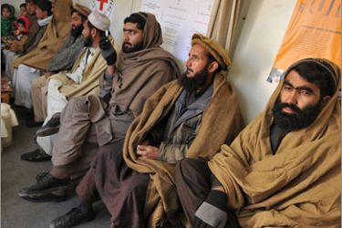 AFPAfghan men wait before communicating via video-conference with detainees held at the US base in Bagram, at the International Committee of the Red Cross