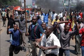 r - Opposition supporters burn vehicles and block the road during a protest in Kisumu, western Kenya, as a police officer shot dead an opposition legislator on January 31
