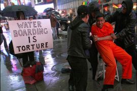 AFP PHOTO /Demonstrators from the group "World Can't Wait" hold a mock waterboarding torture of a prisioner in Times Square 11 January 2008