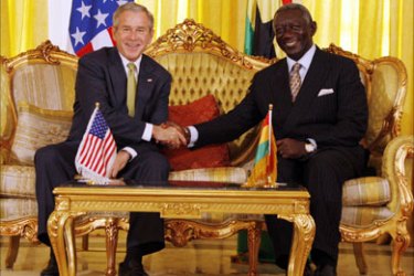 U.S. President George Bush (L) shakes hands with Ghana's President John Kufuor during a bilateral meeting at Osu Castle in Accra, February 20, 2008.
