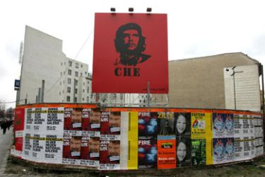A poster featuring a portrait of Argentine revolutionary Ernesto "Che" Guevara stands in a vacant lot during the 58th Berlin International Film Festival (Berlinale) in Berlin