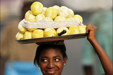 afp - A Ghanaian vendor sells fruits in city center of Accra, 01 Feburary 2008, during the African Cup of Nations football championship.