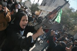 The sister of Palestinian Abed al-Nasser Abu Nasser, one of the seven Hamas’ members killed during an Israeli air raid the previous day in Khan Yunis in the Gaza Strip, shoots in the air during his funeral on February 6, 2008