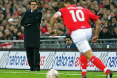 afp - England's Manager Fabio Capello (L) watches England's Captain Steven Gerrard (R) running with the ball during their international friendly match against Switzerland