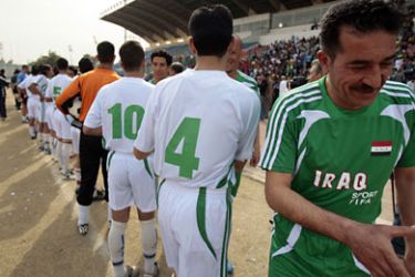 ف-Iraqi football players from Khadamiya, a Shiite neighborhood, greet players from Adhamiyah, a Sunni neighborhood, before an exhibition match at the al-Shaab stadium in central Baghdad on February 17, 2008. The teams gathered for the match to celebrate the one year