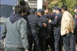 AFP PHOTO / Alleged members of an Islamist group are loaded into a van on February 28, 2008 in Rabat.