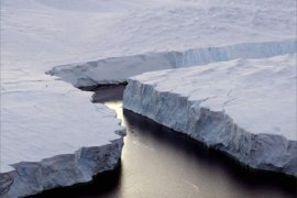 An enormous iceberg (R) breaks off the Knox Coast in the Australian Antarctic Territory, January 11, 2008