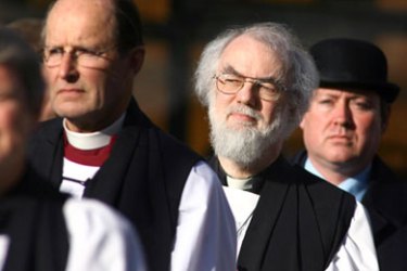 The leader of the world's Anglicans, Archbishop of Canterbury Rowan Williams (2ndR) arrives at a memorial service at the Great St Mary's Church in Cambridge