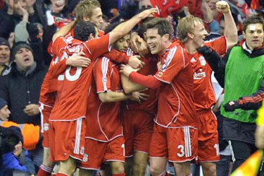 Liverpool players celebrate with Steven Gerrard after he had scored the second goal during their first round first leg Champions League football match against Inter Milan at Anfield in Liverpool, north-west England, on February 19,