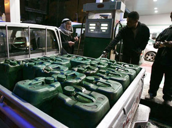 A Jordanian man fills containers with diesel at a fuel station in Amman late February 7, 2008 before the government announced its decision on deregulating the oil prices