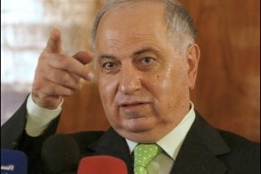 r/Ahmad Chalabi, head of the Accountability and Justice Commission, gestures towards reporters during a news conference in Baghdad February 2, 2008.