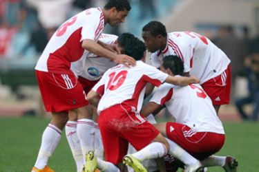 Tunisia Etoile du Sahel players congratulate their teammate Amine Chermiti (C) after he scored a goal against Tunisian Club de Sfax in an African Super Cup Confederation match