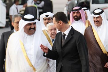 AFPSyrian President Bashar al-Assad (R) receives Qatari Emir Sheikh Hamad bin Khalifa al-Thani at Damascus airport upon his arrival in Syria