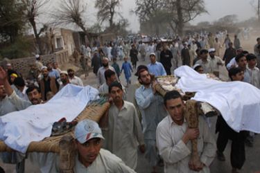 Tribesmen carry bodies after clashes between two religious groups in the Bara area of the Khyber Agency near Peshawar