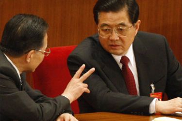 China's President Hu Jintao (R) listens to Premier Wen Jiabao before the start of 2nd plenary session of China's parliament, National People's Congress, at the Great Hall of the People in Beijing March 8, 2008.