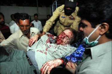 afp - Pakistani volunteers carry a bomb blast victim outside a hospital in Islamabad on March 15, 2008. A blast has hit a restaurant frequented by foreigners in the Pakistani capital