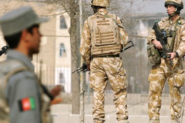 An Afghan security guard (L) and British soldiers with the NATO-led International Security Assistance Force (ISAF) stand guard at the site of a suicide attack in Kabul on March 13, 2008. A suicide car bomb attack against foreign forces in the Afghan capital