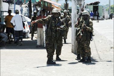 r : Comoros commandos patrol the streets of Anjouan island March 26, 2008. Comorian rebel leader Mohamed Bacar has fled to the French-run Indian Ocean island of Mayotte, a