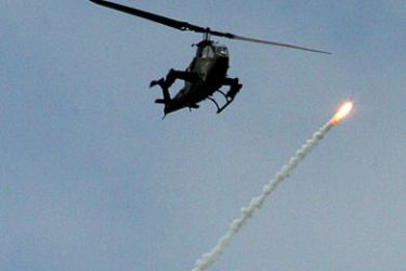 An Israeli army helicopter shoots flares into the air during a military operation in the Gaza Strip