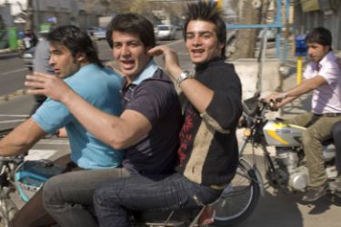 R/ Young men ride motorcycles on a street in southern Tehran March 8, 2008. Iranian students, who spearheaded a reform movement blunted by President Mahmoud Ahmadinejad's election in 2005, doubt that voting for a new parliament on March 14 can promote real change. Picture taken March 8, 2008. To match feature IRAN-ELECTION