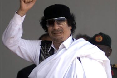 f_Libyan leader Moamer Kadhafi greets participants with a clinched fist at Nakivugo Stadium during a prayer service on March 19, 2008. Kadhafi later attended the official