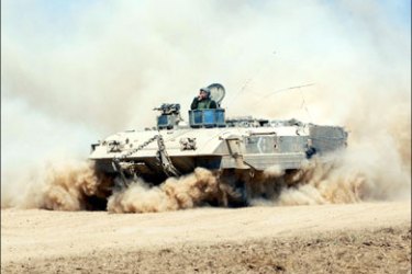 afp : An Israeli armoured personnel carrier rolls out of the Gaza Strip into Israel near the Kisufim crossing on April 27, 2008. Palestinian president Mahmud Abbas gave his
