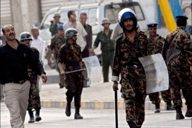 afp : Yemeni police monitor demonstrators in the al-Maalla district of Aden city on April 8, 2008 as protests continued in southern Yemen. The protests in the south of the country