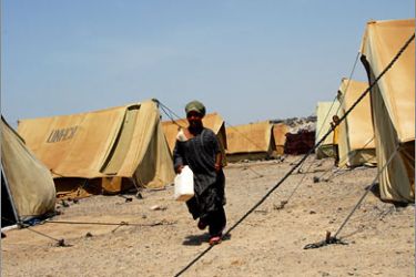 AFPA Somali woman refugee walks past United Nations donated tents on April 30, 2008 in Kharaz refugees camp some 150 km west of Aden, where