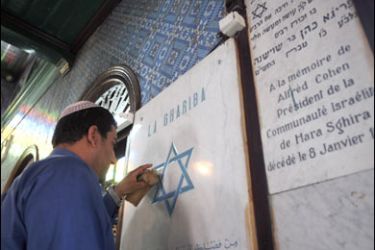 f/Haiem Trabelsi, an employee cleans an engraved Star of David at the Ghriba Synagogue on May 20 2008