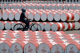 AFP / A worker of state oil company Pertamina cycles past barrels filled with fuel in Jakarta on May 6, 2008. Indonesia's government confirmed it will raise its subsidised fuel prices