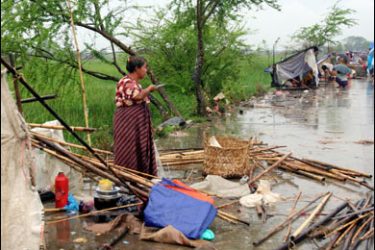 f/A displaced woman looks for her belongings as she prepares to leave to avoid harsh weather in Shwepoughkan township some 32 kilometers from Myanmar's biggest city Yangon on May 20, 2008.