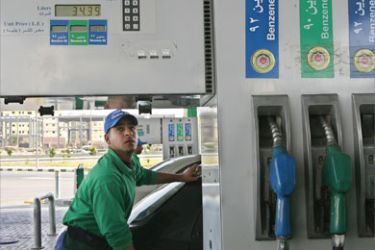 An Egyptian worker fills a car with petrol at a gas station in Cairo on May 6, 2008
