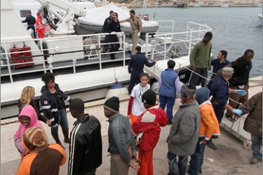 AFP Some of the 234 illegal immigrants arrive in the port of Lampedusa after being intercepted by the Italian coastguard, 15 nautical miles off the island,