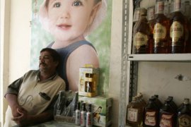 A liquor store owner waits for customers inside his shop in Baghdad May 24, 2008