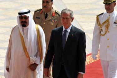 Saudi King Abdullah (front-L) and US President George W. Bush (front-R) walk on the red carpet during a welcoming ceremony for the latter upon arrival at King Khaled