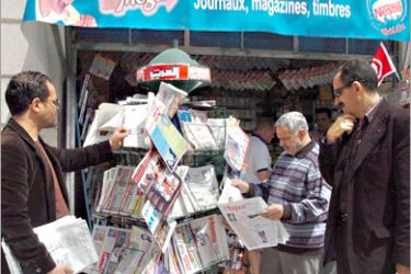 AFP / Tunisian people look at the stock of newspapers in a shop on May 03, 2008 in Tunis the international day for Press. Reporters Without Borders (RSF) media rights group.,