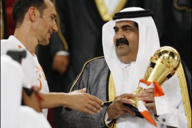 r/Qatar's Amir Sheikh Hamad bin Khalifa al-Thani (R) holds the trophy before presenting it to Umm Salal's Aziz Ben Askar from Morocco after the final match between Umm Salal and Al-Gharafa of the Qatari Amir Cup soccer tournament in Doha May 15, 2008.