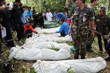 afp : Thai rescuers and soldiers stand next to dead bodies from a military helicopter crash in Thailand's restive southern Pattani province on June 20, 2008. Ten people were killed
