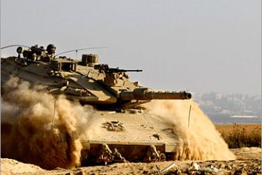 AFP - An Israeli Merkava tank leaves its position at an Army outpost near the Kissufim crossing hours into a truce agreement between Israel and militants of the Gaza Strip. A fragile truce between Israel and the Palestinian Islamist movement
