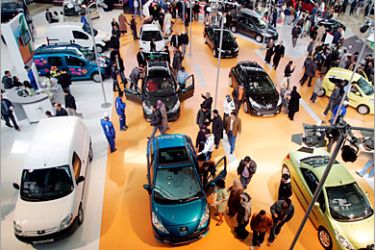 epa01298541 Algerian visitors view cars at the Peugeot stand during the International Auto Show in Algiers, 28 March 2008. Thousands of visitors are expected to visit to the show