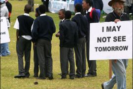 AFP PHOTO/South African demonstrators of the Million Man March against crime hold up placards on June 10, 2008