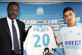 Former Lyon's France international midfielder Hatem Ben Arfa poses with his shirt with Olympique de Marseille's president, Pape Diouf (L)