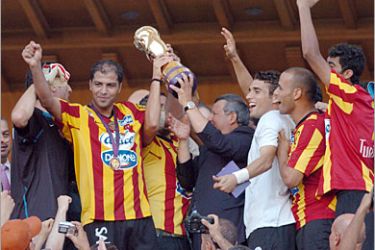 AFP / Esperance de Tunis team celebrates with the trophy after the Tunisia Cup final football match against Etoile du Sahel at Rades Stadium in Tunis, on July 5, 2008. Esperance won 2-1